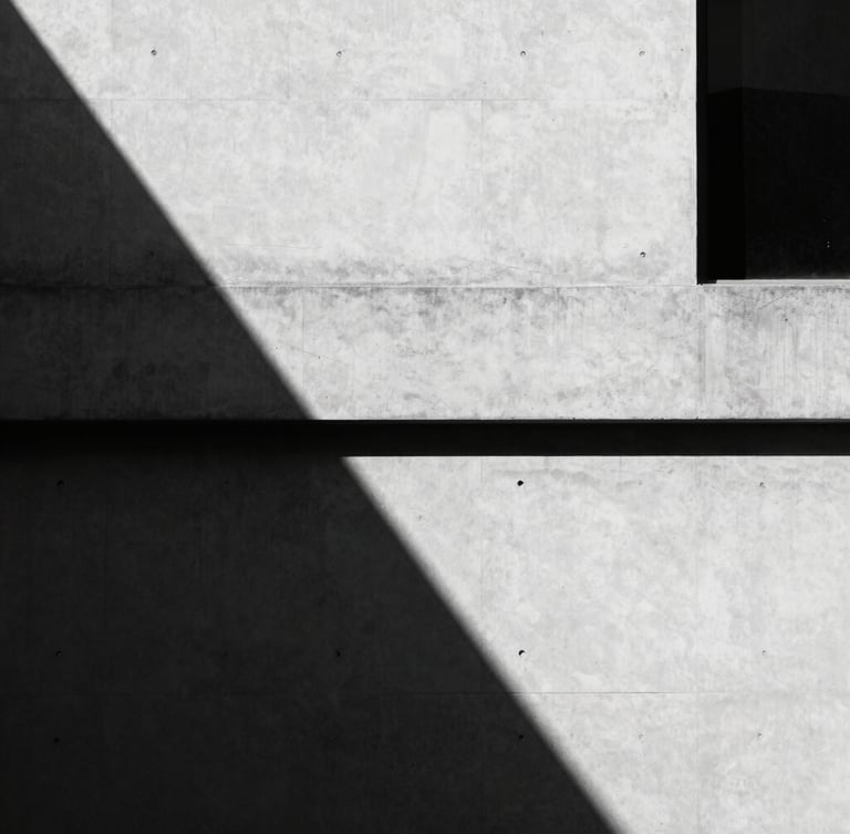 Minimalist architectural crop of a modern concrete building facade in Manila, sharp shadows, high contrast black and white, 35mm lens.