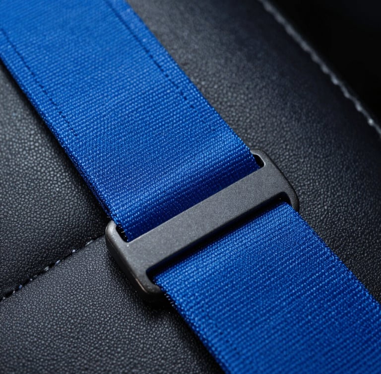 Extreme macro close-up of vibrant electric blue seatbelt fabric being stitched with clinical precision under cool studio lighting, dark leather background