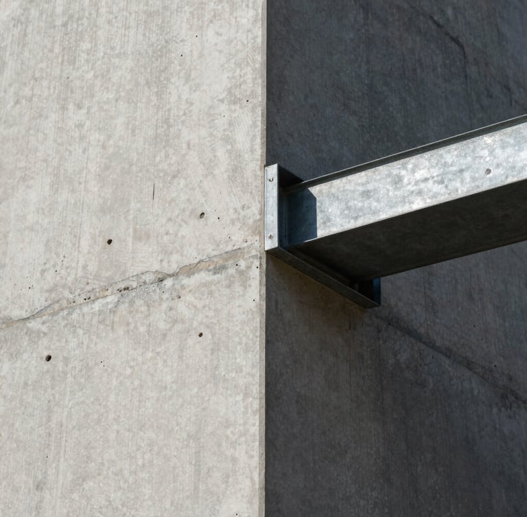 Extreme close-up of a raw board-formed concrete wall meeting a sharp steel beam under harsh, direct midday sunlight, casting deep architectural shadows.