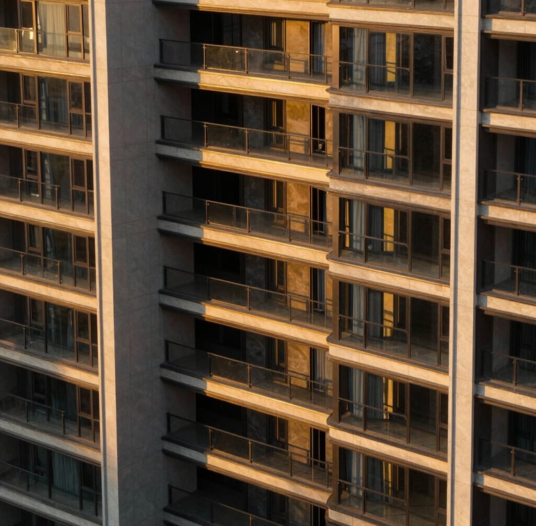 High-contrast architectural close-up of a modern luxury estate facade, golden-hour sunlight casting long dramatic shadows, 35mm