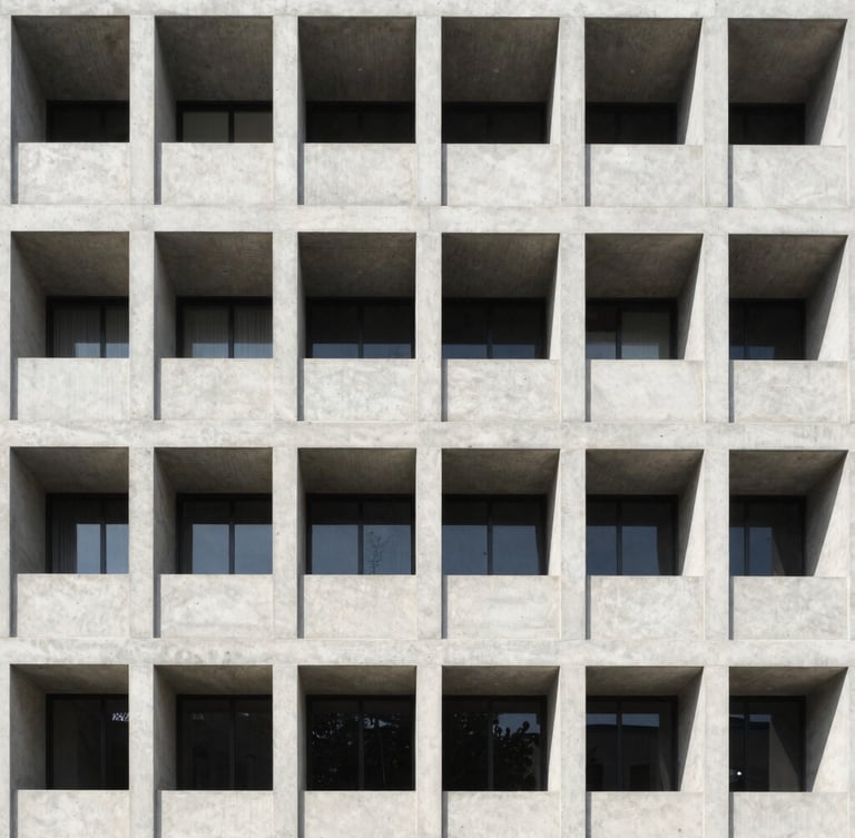 Symmetrical architectural shot of a modern concrete building facade, bright natural daylight, clean technical lines