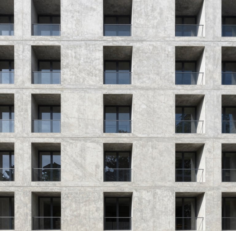 Symmetrical architectural photography of a modern concrete building facade, sharp lines, bright natural daylight, technical blueprint feel.