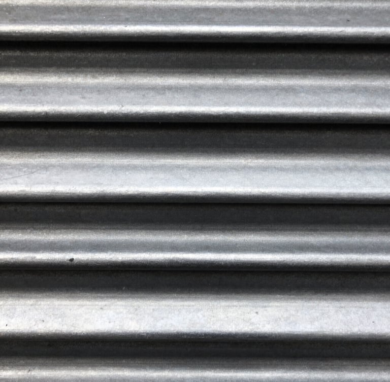 Macro shot of steel roller shutter mechanism, high-contrast metallic highlights, industrial editorial photography, sharp focus, 35mm