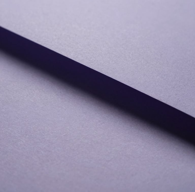 Extreme close-up of folded textured paper casting soft lavender and gray shadows under diffused overcast daylight, minimalist composition.
