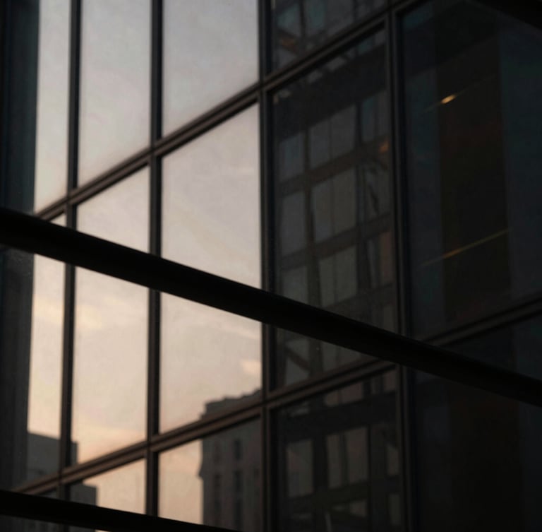 Macro photograph of architectural glass reflecting sharp, dramatic side-lighting, deep obsidian shadows, warm champagne highlights, ultra-premium editorial aesthetic.