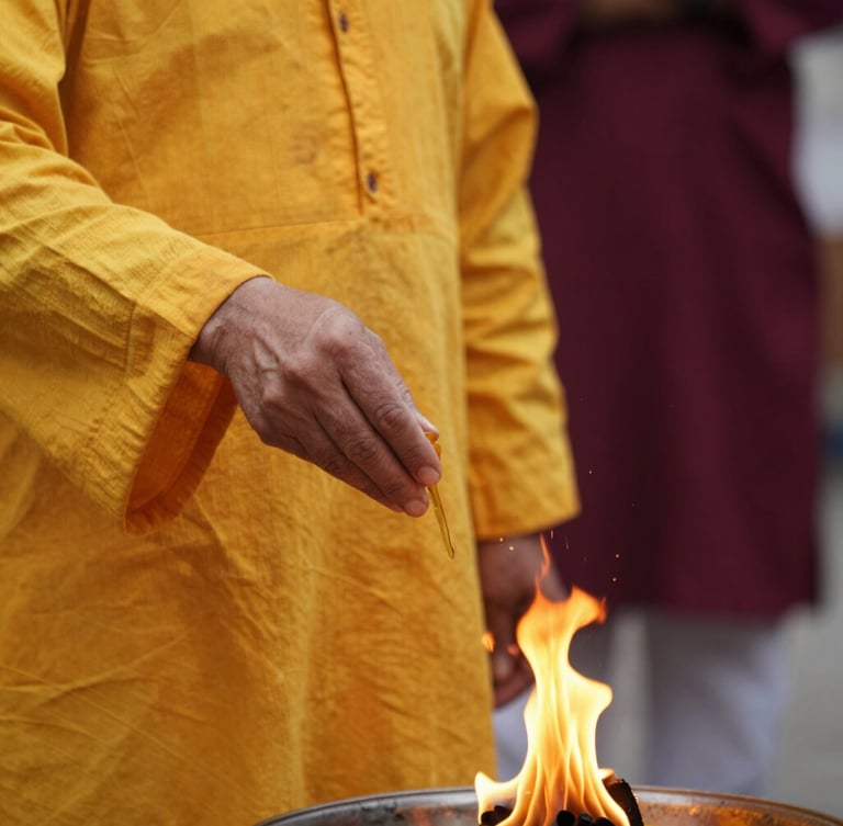 Close-up of a priest in traditional saffron attire pouring ghee into a sacred fire, warm golden glow, shallow depth of field, editorial photography