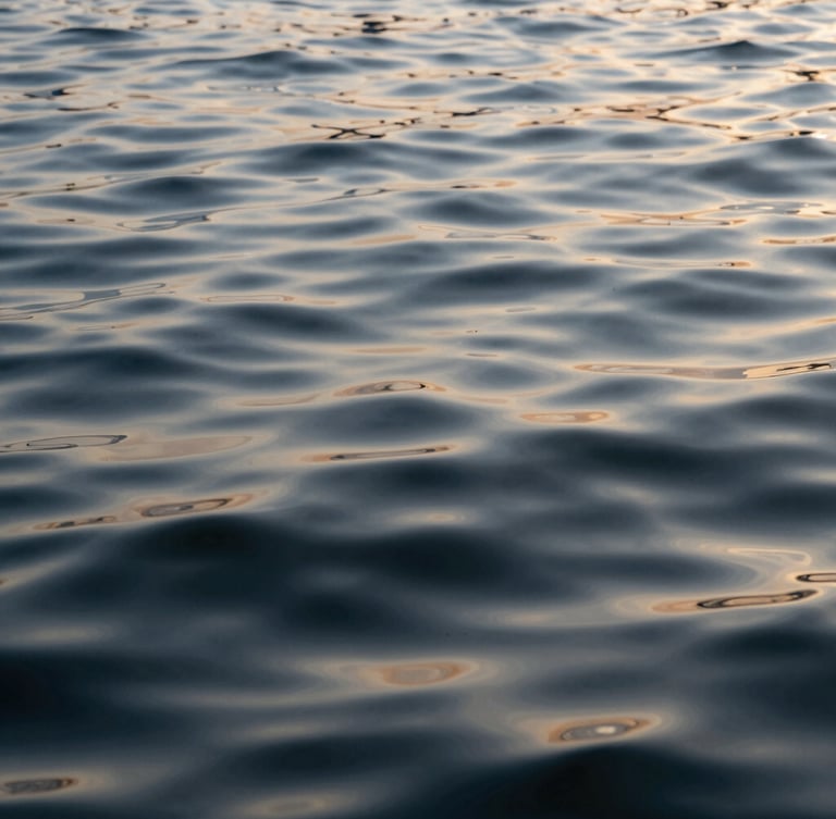 Rippling water surface with soft morning light reflections, calm and abstract natural texture.