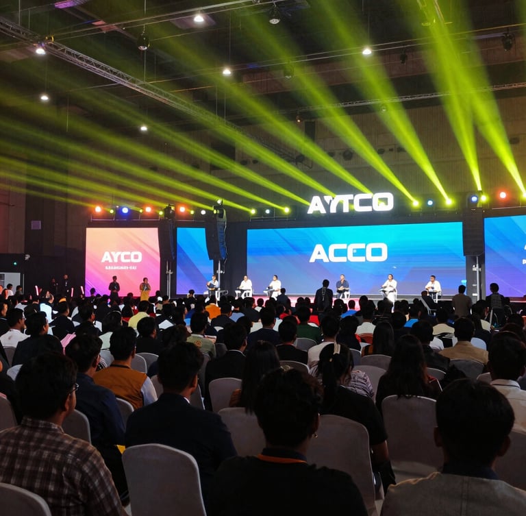 Wide environmental shot of a packed tech conference in Bangalore, bright colorful stage lighting, dynamic perspective