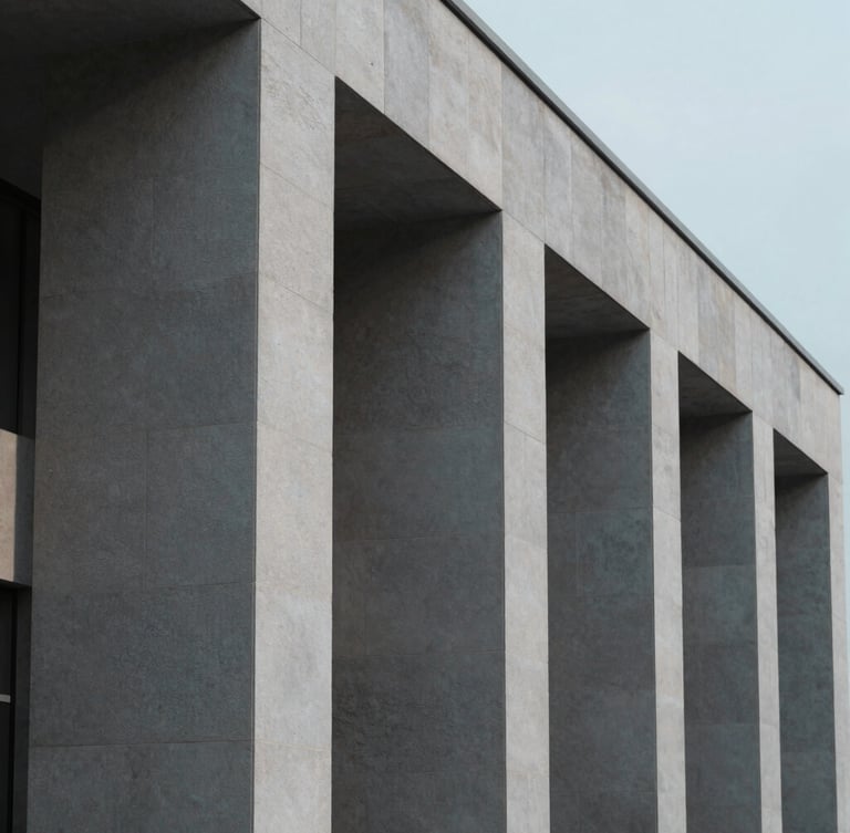 Minimalist architectural detail of a stable modern stone building, shadow lines from clean pillars, soft cool overcast daylight, desaturated tones