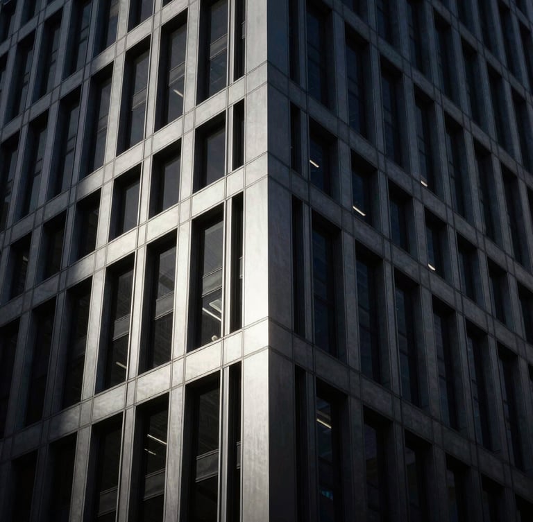 Moody architectural photography of a modern high-end financial district skyscraper corner, low-key dramatic lighting, deep charcoal and brushed silver tones, high contrast, 35mm