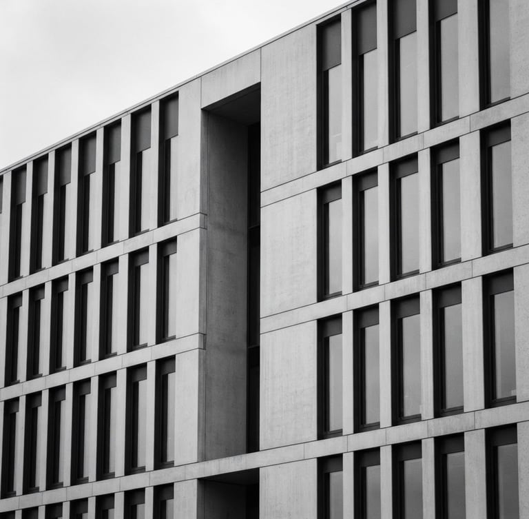 Minimalist architectural detail of a modern courthouse facade, soft overcast daylight, desaturated black and white, elegant corporate aesthetic, 35mm