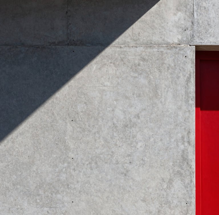 Close-up of pristine acrylic render texture on a concrete wall, sharp morning light casting clean geometric shadows, architectural detail.