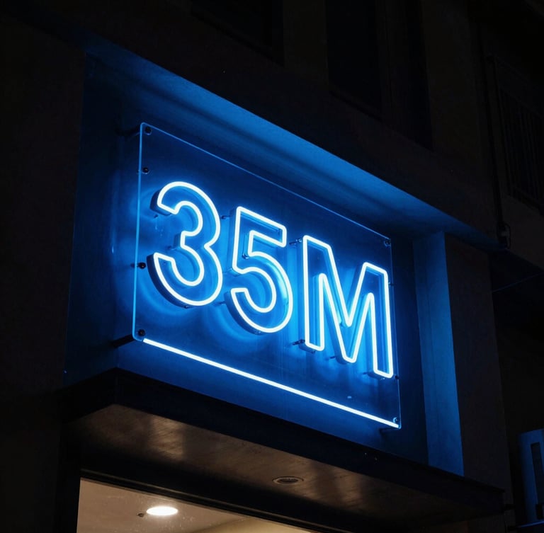 Dramatic night-time architectural photography of a glowing 3D acrylic sign board on a modern shop facade in Hyderabad, intense electric blue neon illumination, high-contrast dark-mode aesthetic, 35mm lens