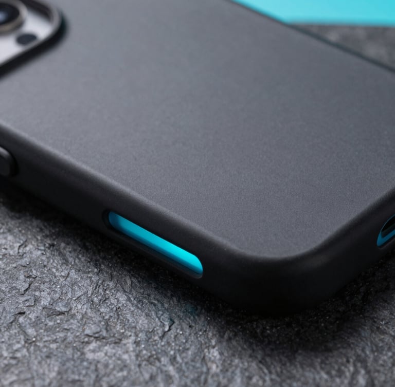 Extreme close-up of a premium matte black phone case on a dark stone surface, sharp edges, illuminated by a sharp neon cyan side-light, macro photography.