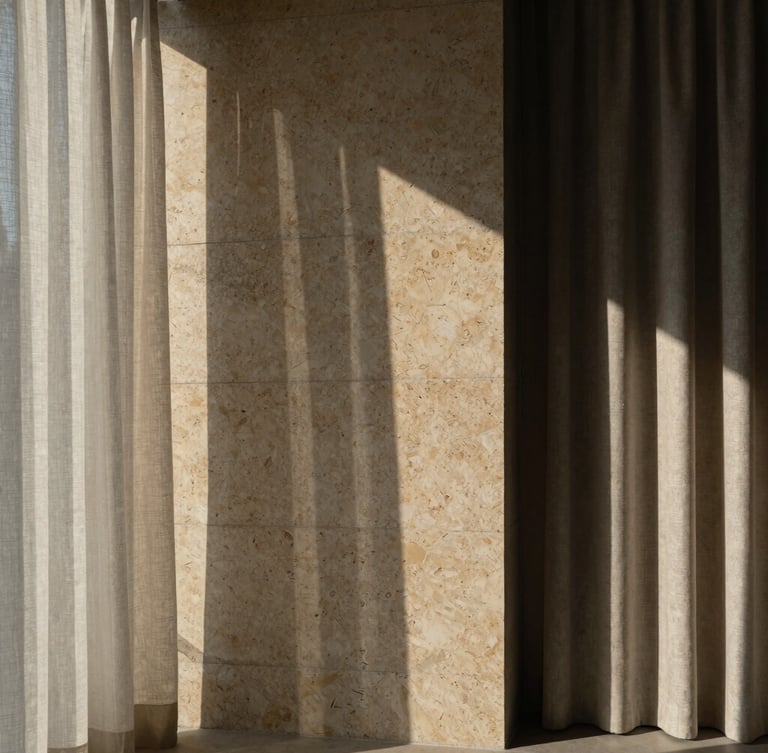 Architectural photography of a brutalist luxury concrete wall meeting warm travertine stone and soft linen curtains, dramatic natural side light, deep shadows, Hasselblad medium format.