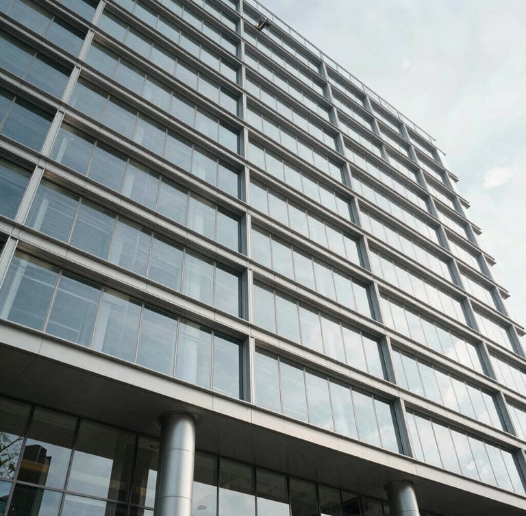 Low-angle architectural shot of a modern glass-and-steel government building facade, bright daylight, sharp structural lines.