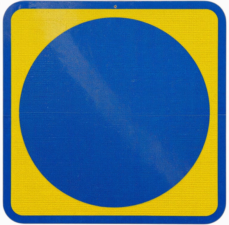 Macro shot of a reflective blue and yellow industrial safety sign, showing the honeycomb texture of the reflective vinyl, high contrast daylight, sharp focus