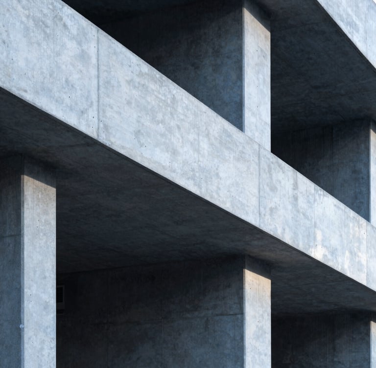 A vertical portrait of clean industrial workspace architectural details, sharp concrete lines, cool daylight casting deep shadows.