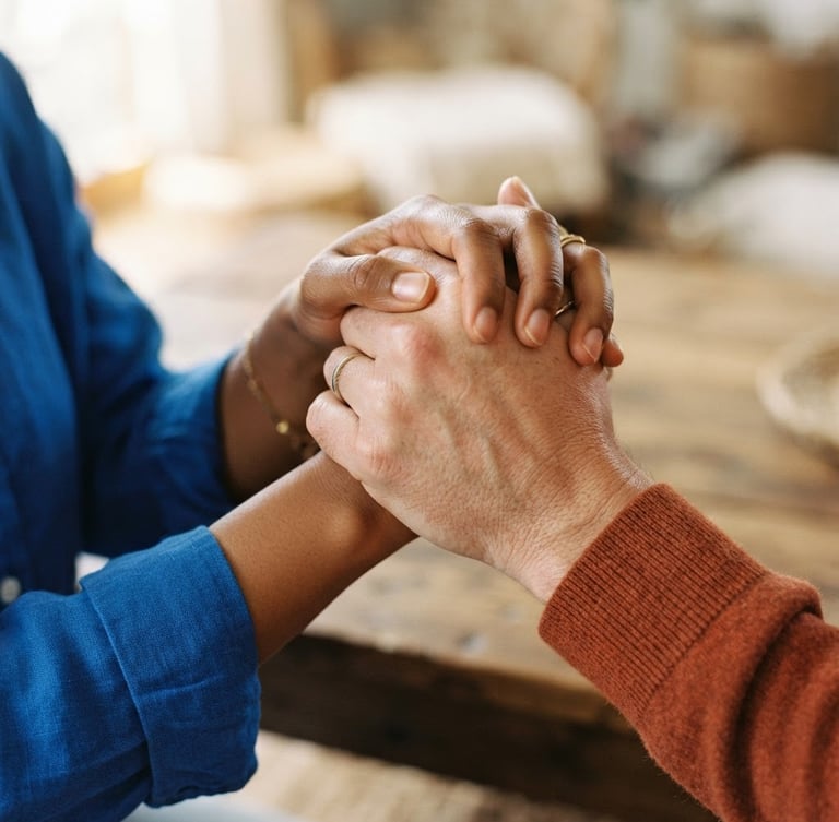 Close-up of two diverse hands clasped firmly in solidarity, warm natural daylight, soft focus, 35mm editorial photography, royal blue and orange accents.