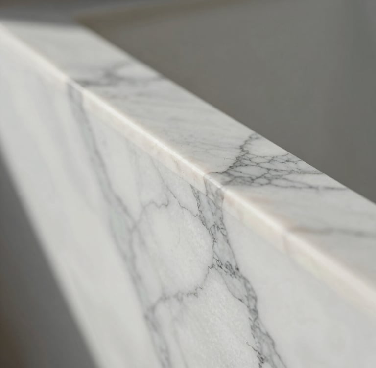 An extreme close-up portrait shot of polished white Calacatta marble with delicate grey veining, soft natural morning light catching the flawless edge.