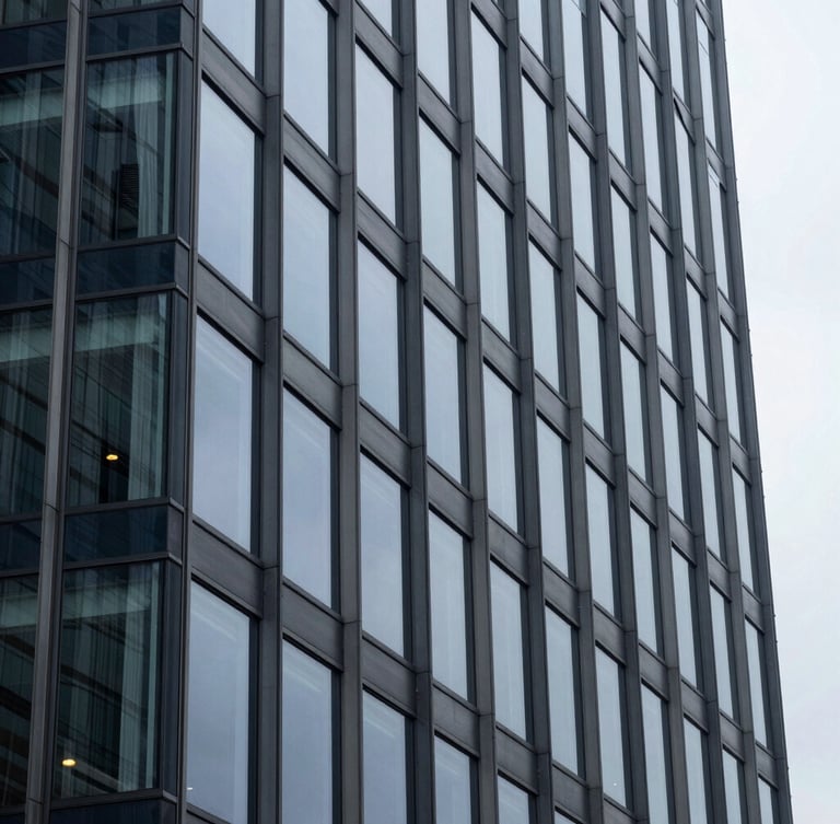 Close-up architectural detail of a modern glass office building facade, sharp geometric lines, cool overcast daylight, navy and slate gray tones