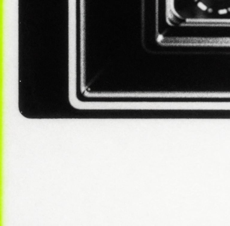 Extreme close-up of photocopied paper texture with harsh high-contrast black and white grain, distorted retro hardware, 35mm film style