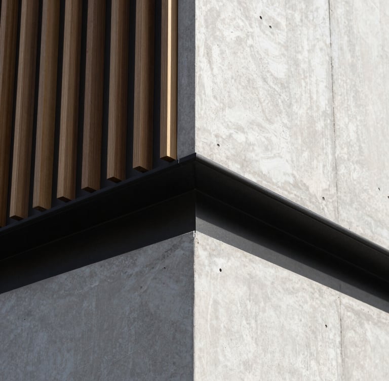 Tight details of craftsmanship on a modern timber and concrete wall interface, sharp natural daylight, architectural precision