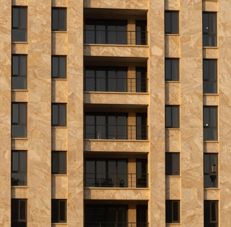 A sharp, high-contrast architectural crop of a high-end residential development in Riyadh, warm golden-hour light reflecting off limestone panels, minimalist landscaping