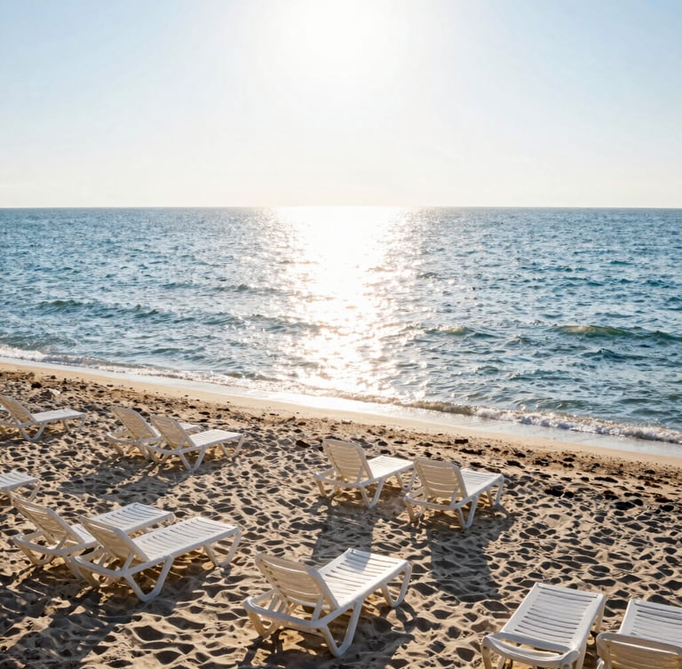 Wide environmental shot of a clean Romanian beach at sunrise, golden light reflecting on the calm Black Sea waves, empty sunbeds, high-key natural lighting