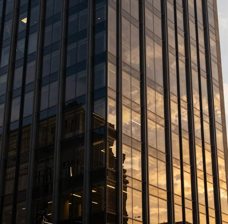 Warm editorial corporate photography, soft window light reflecting on modern glass facade of a São Paulo office building, deep navy and gold tones, 35mm