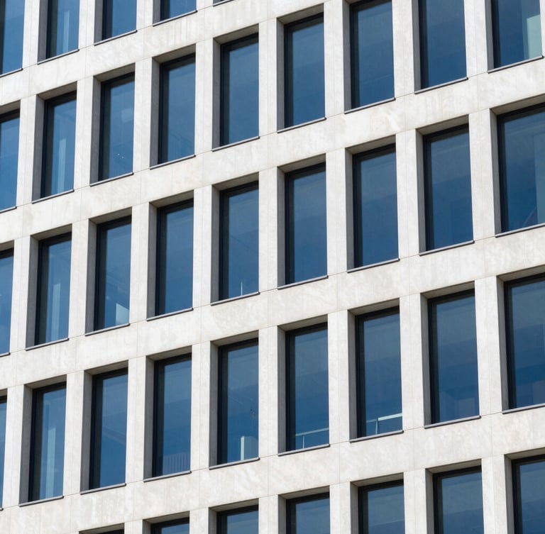 Sharp architectural close-up of modern office building window lines reflecting daylight, clean geometric shadows, 35mm lens