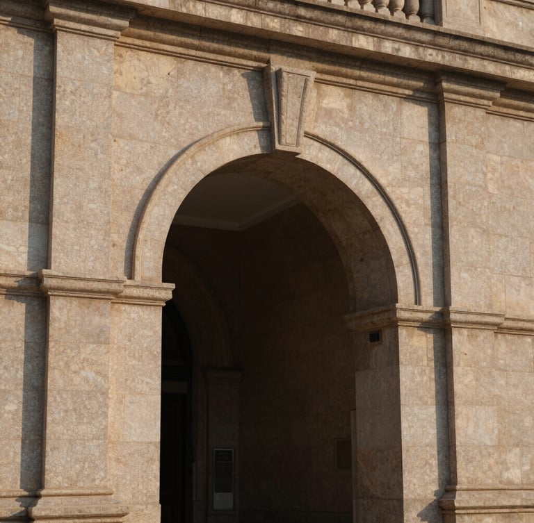 Architectural detail of a massive stone archway, strong shadows, warm afternoon light reflecting on structured granite, elegant and protective, 35mm.