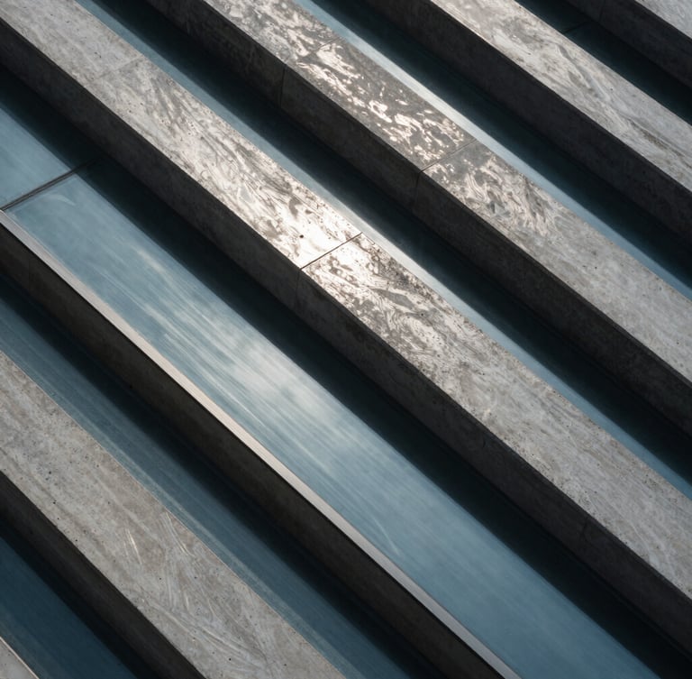 Extreme close-up of architectural concrete and glass lines, cool-toned lighting with sharp silver reflections, high-angle perspective.