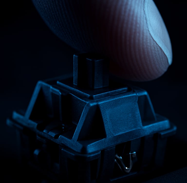 Extreme macro studio photograph of a mechanical keyboard switch being pressed by a finger, dramatic high-contrast lighting with deep blue shadows, sharp focus on the metallic contact points