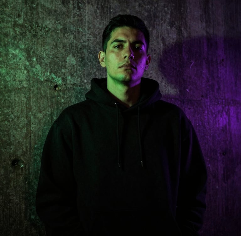 Low-angle gritty portrait of SergioMdrz in a dark concrete alley, wearing a black hoodie, neon green gel light casting sharp shadows, high contrast, 35mm photography