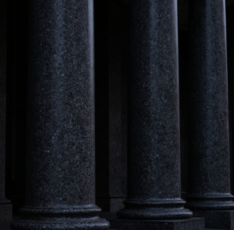 Low-key high-contrast macro photography of dark granite columns, deep shadows, structural finance architecture, 35mm