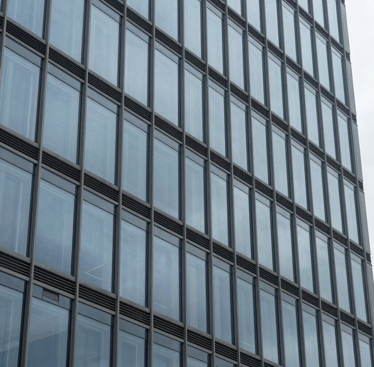 Macro detail of a modern steel and glass skyscraper facade, clean geometric patterns, cool overcast light, architectural stability, 35mm
