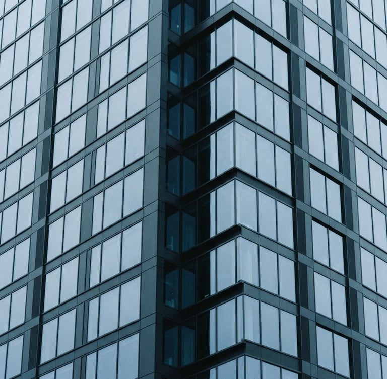 Minimalist architectural photography of a modern financial district building, cool overcast daylight, sharp geometric lines, desaturated blue and slate tones, 35mm