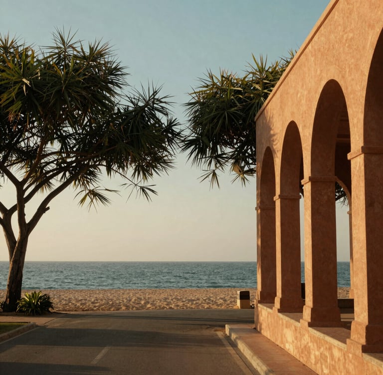 A peaceful coastal road leading toward the Tajpur sea beach, framed by Casuarina trees under warm golden-hour hazy sunlight, architectural detail