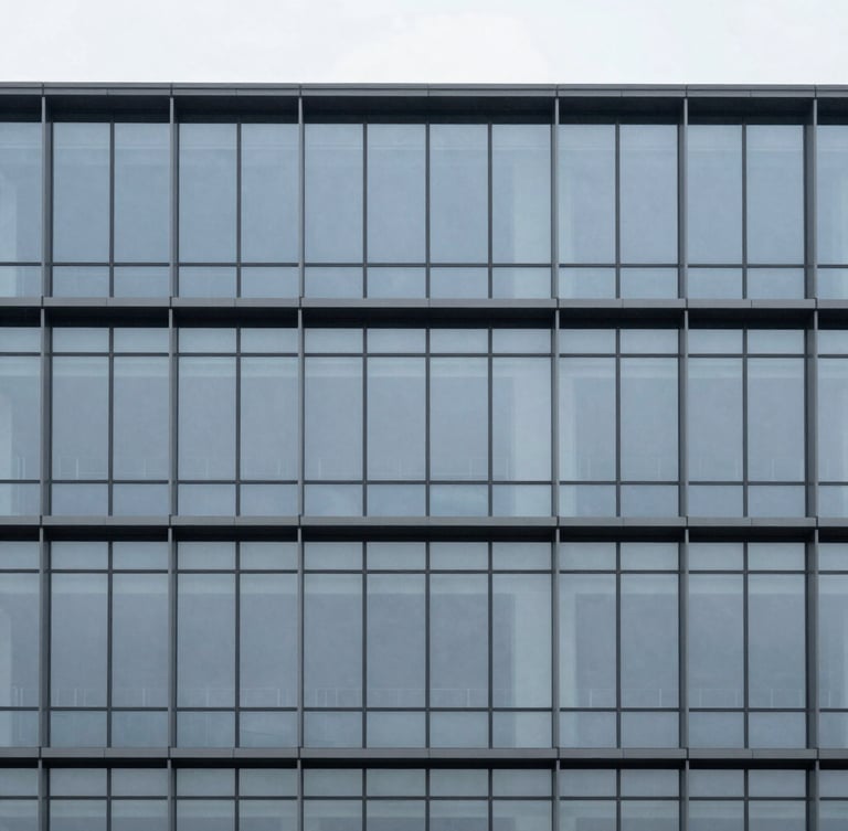 Minimalist architectural photography of a modern corporate building facade, clean geometric glass and steel lines, cool overcast daylight, desaturated slate tones, sharp focus, 35mm