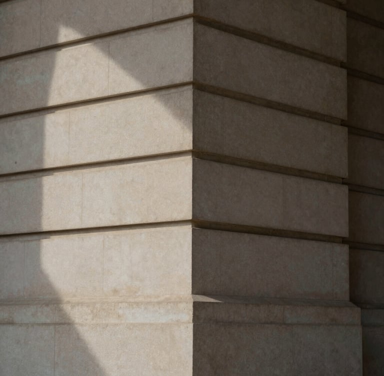 Abstract architectural detail of a classic stone facade with deep geometric shadows, soft indirect natural light, elegant and sober, 35mm photography.