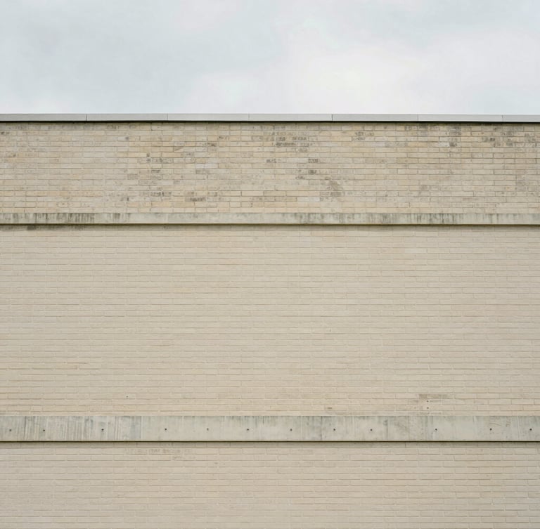 Straight-on architectural crop of a brick and concrete building facade, clean lines, soft natural overcast daylight, minimal composition, 35mm lens