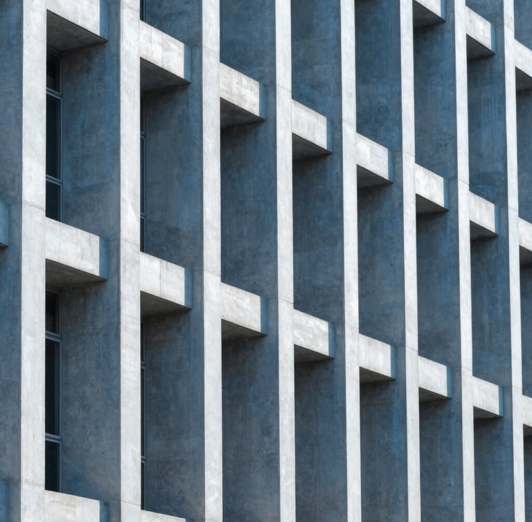 Sharp architectural photography of a modern building facade in Rio de Janeiro, highlighting structural columns, clean daylight, cool blue tones