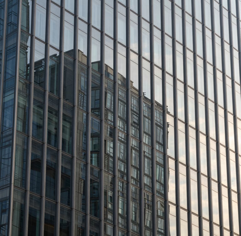 Tight macro architectural detail of a modern high-rise glass facade with sharp morning shadows, high-contrast structural lines, 35mm architectural lens.