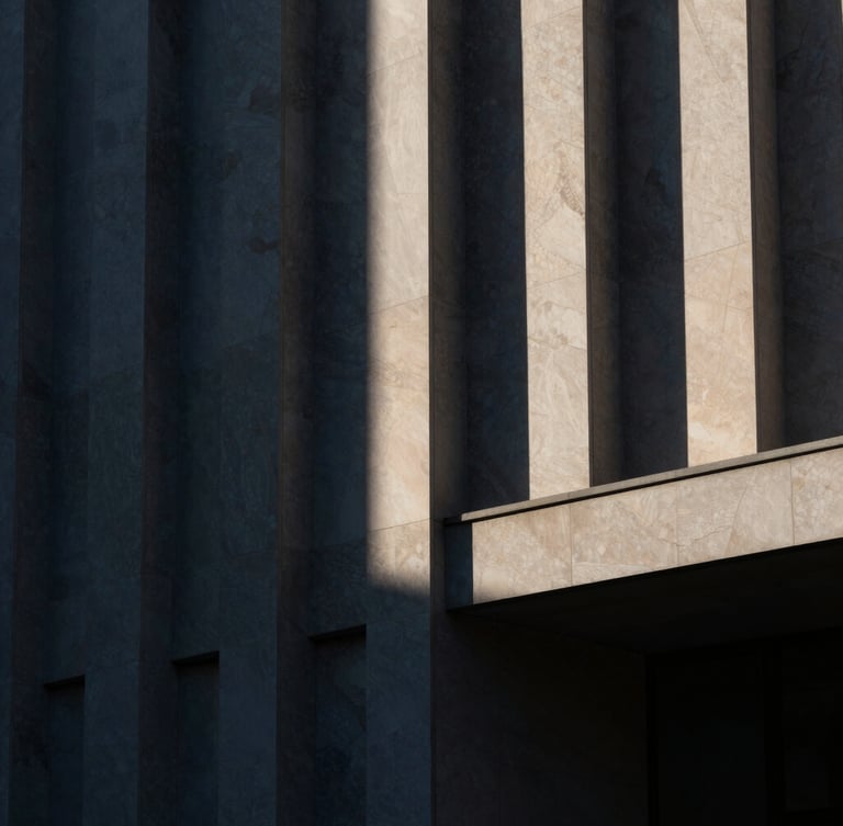 High-contrast architectural detail of a modern library facade, geometric stone patterns, dramatic side-lighting, deep navy and warm ivory tones, moody editorial style
