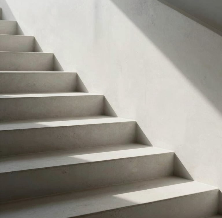 Abstract architectural detail of clean white concrete stairs casting soft, geometric shadows under bright, diffused daylight.