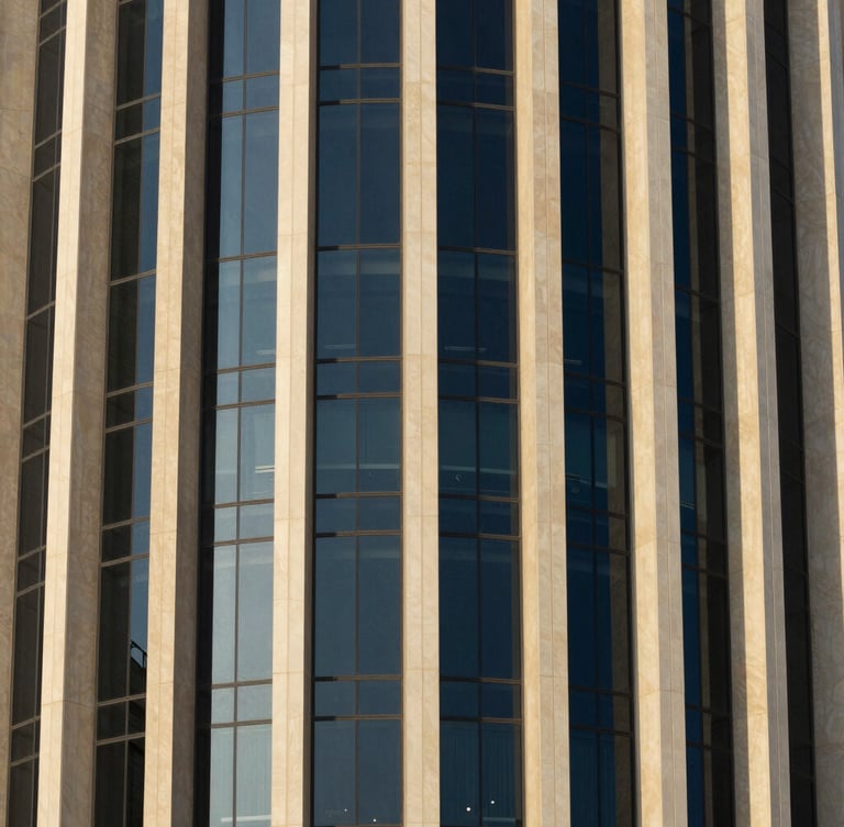 Close-up of modern architectural steel and reflective glass facade in Doha, captured in crisp morning light with deep navy shadows