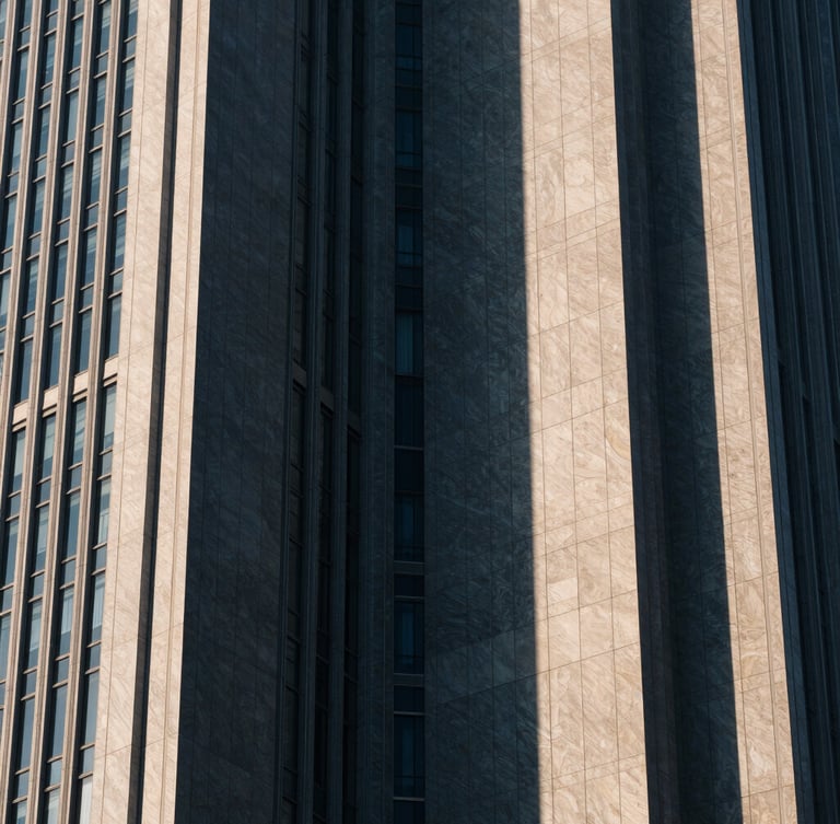 Abstract architectural crop of modern financial district skyscraper, sharp geometric shadows, muted navy and champagne tones, high-contrast, 35mm lens
