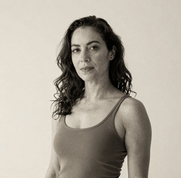 Elegant black and white portrait of dance educator Gwynenn Taylor Jones, soft natural lighting, neutral cream background, warm tones.