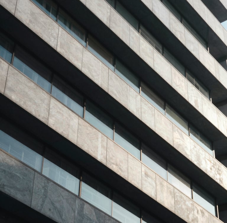 Abstract architectural lines of a modern corporate building, sharp geometric shadows, cool diffused daylight, premium editorial feel.